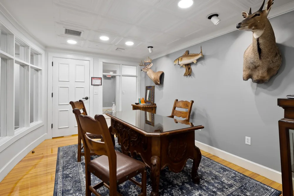 Private office at Society 204 with wood desk and preserved decorative details