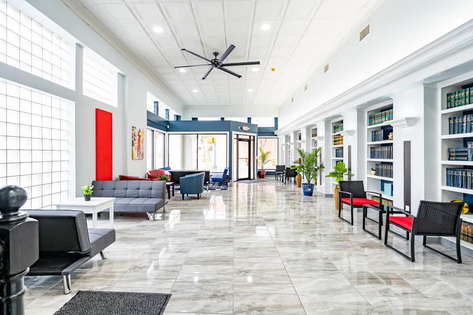 Society 204’s bright shared lobby with high ceilings and lounge seating