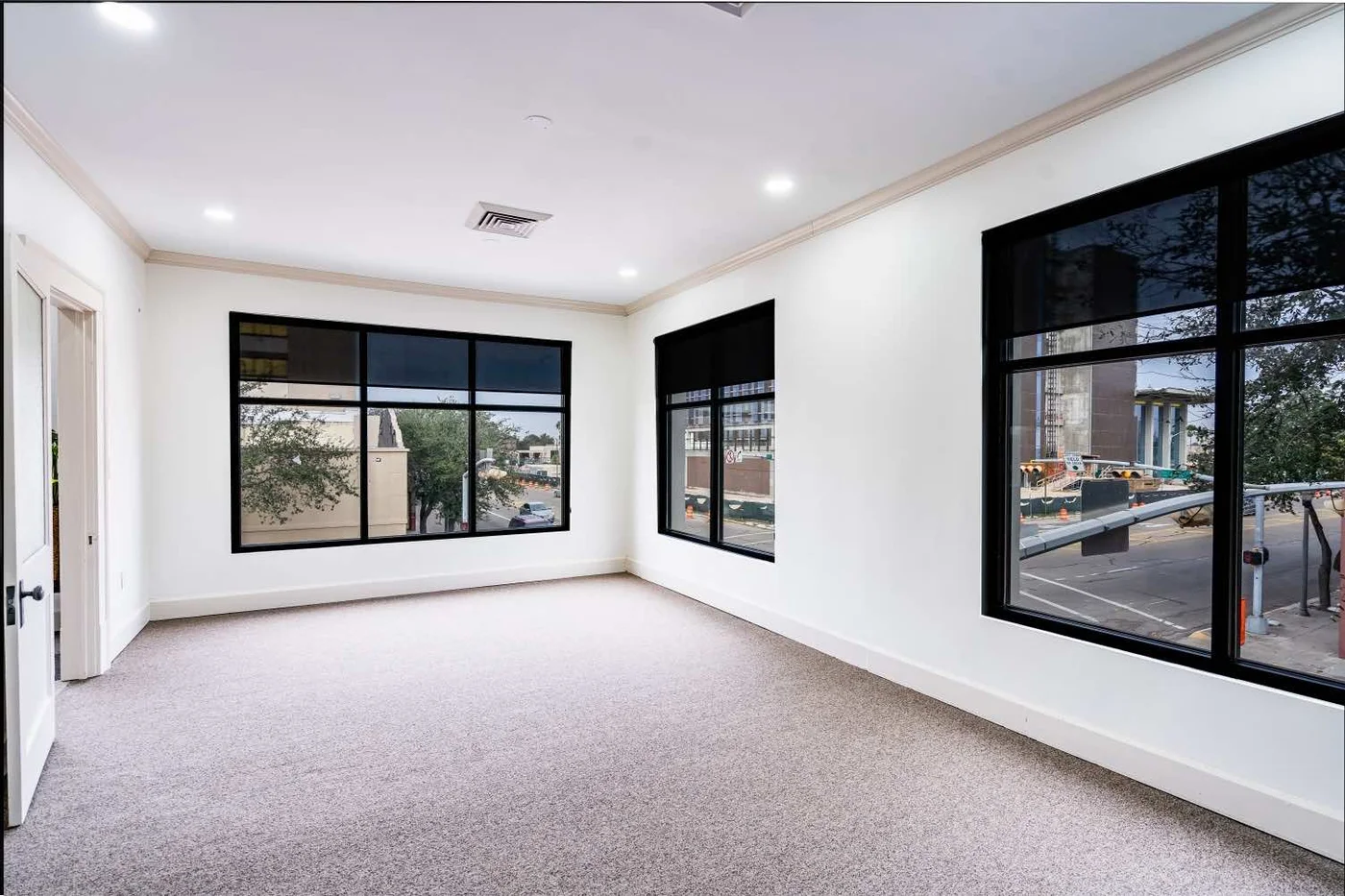Sunlit private office at Society 204 with black-framed windows