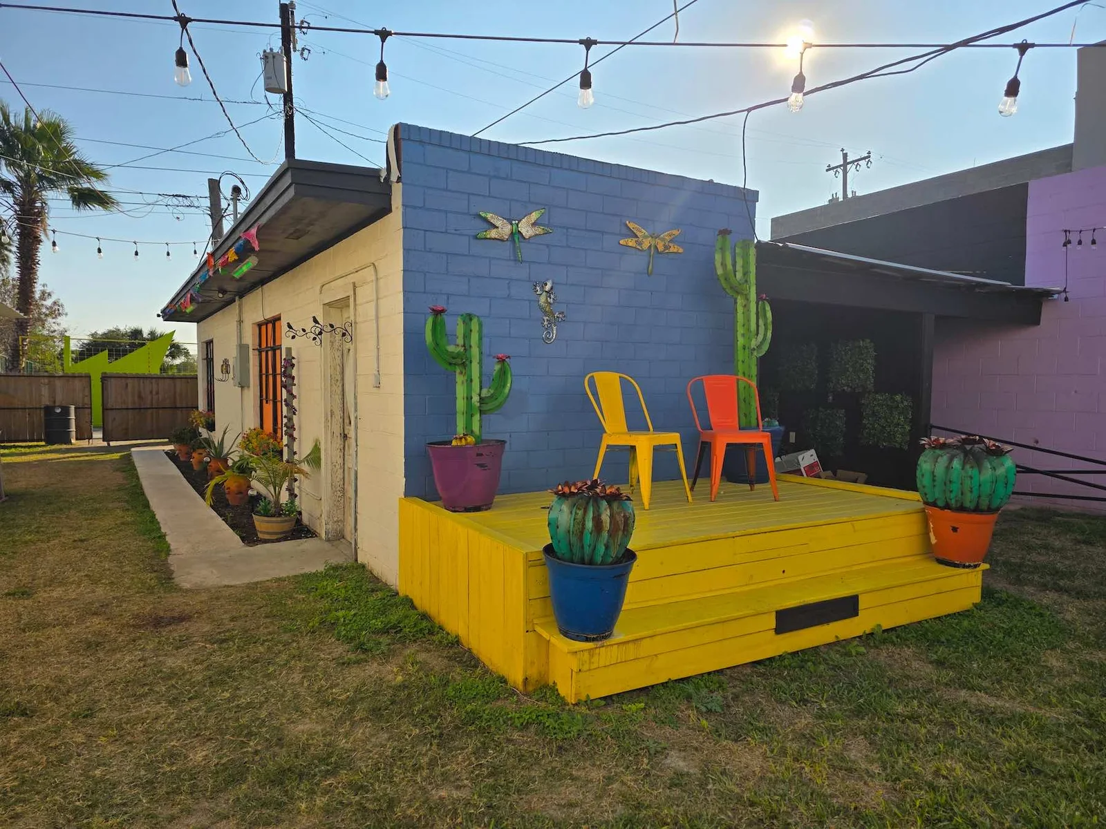 Colorful Society Social courtyard with cactus mural and seating
